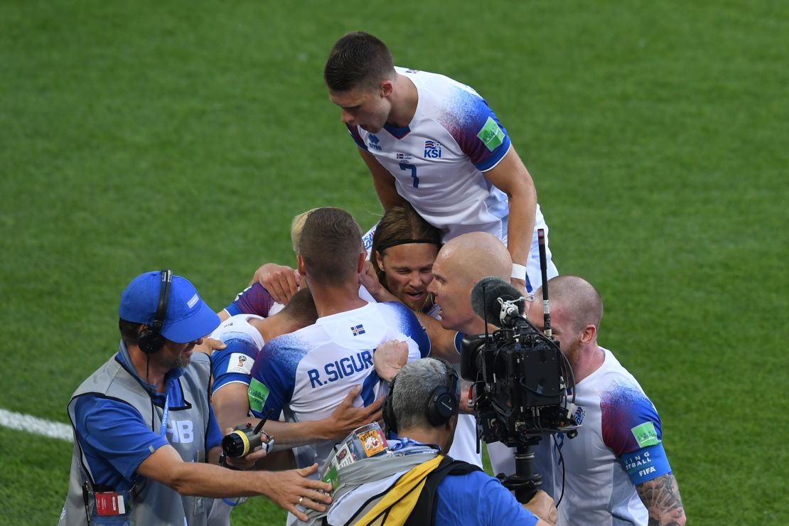 Iceland's forward Alfred Finnbogason (hidden) is congratulated by teammates after scoring against Argentina.