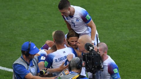 Iceland's forward Alfred Finnbogason (hidden) is congratulated by teammates after scoring against Argentina.
