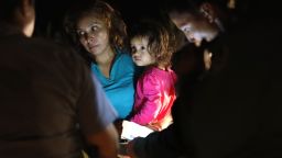 MCALLEN, TX - JUNE 12:  A Honduran mother holds her two-year-old as U.S. Border Patrol as agents review their papers near the U.S.-Mexico border on June 12, 2018 in McAllen, Texas. The asylum seekers had rafted across the Rio Grande from Mexico and were detained by U.S. Border Patrol agents before being sent to a processing center for possible separation. Customs and Border Protection (CBP) is executing the Trump administration's "zero tolerance" policy towards undocumented immigrants. U.S. Attorney General Jeff Sessions also said that domestic and gang violence in immigrants' country of origin would no longer qualify them for political asylum status.  (Photo by John Moore/Getty Images)