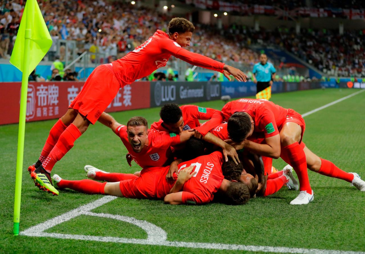 English players celebrate Harry Kane's first goal in the 2-1 win over Tunisia on June 18. Kane later added the winner in second-half stoppage time.