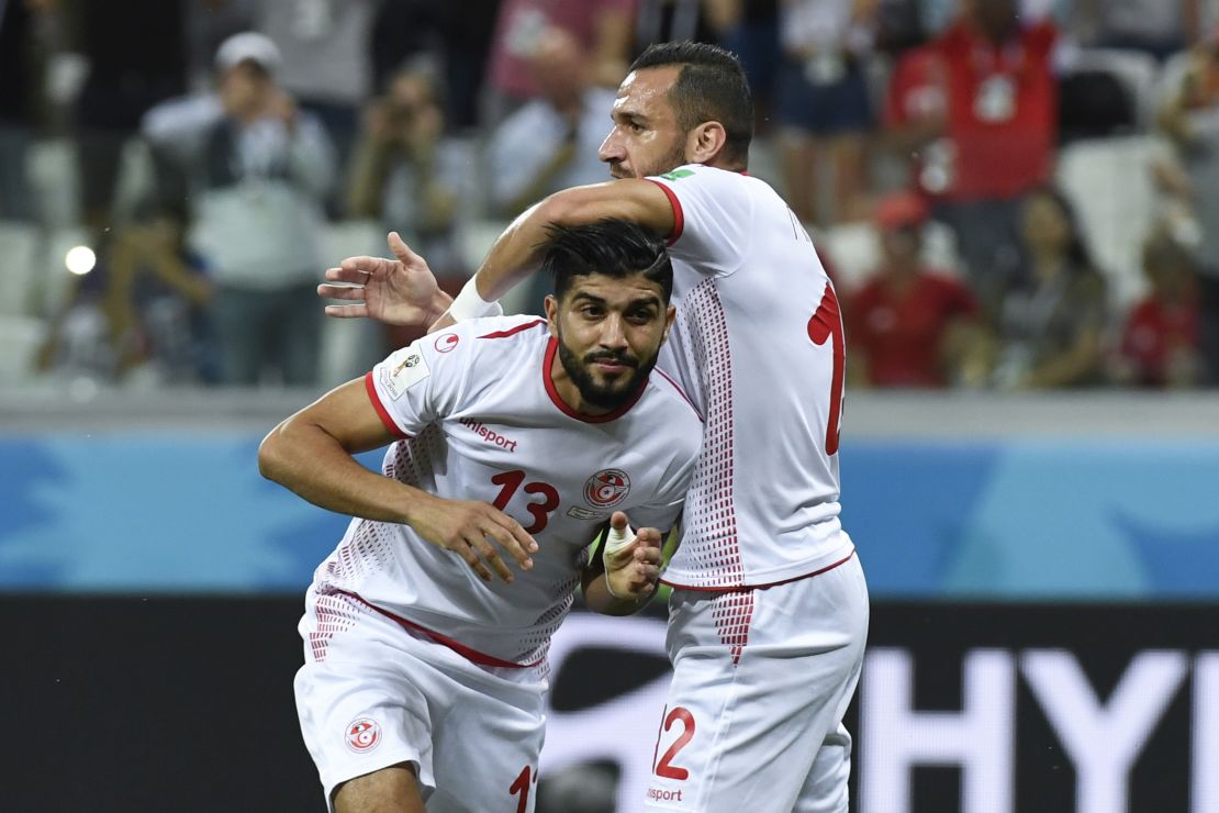 Tunisia's defender Ali Maaloul (R) congratulates Ferjani Sassi for his goal during the Russia 2018 World Cup Group G football match between Tunisia and England.