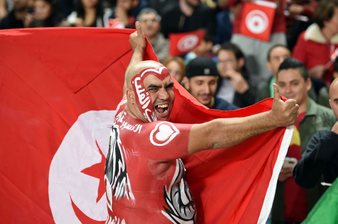 That's quite a lot of face paint ... a Tunisian fan cheers on his team in the World Cup match against England.