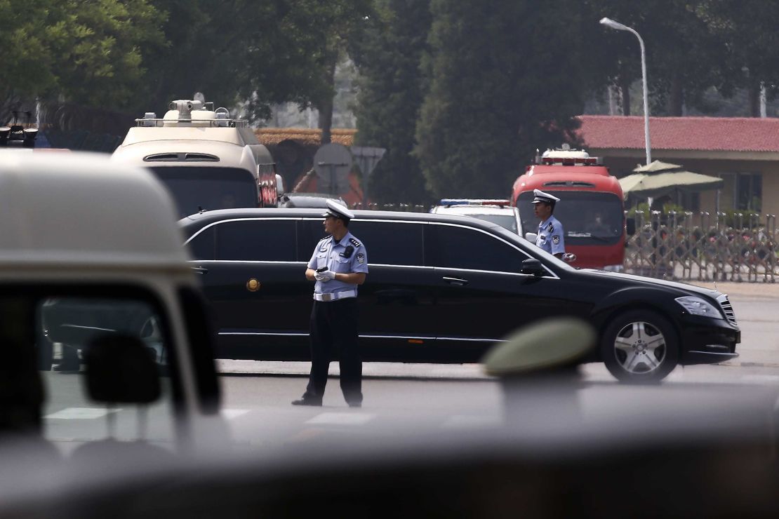 The motorcade in which Kim is believed to be traveling passes by policemen as it leaves the Beijing Capital International Airport.