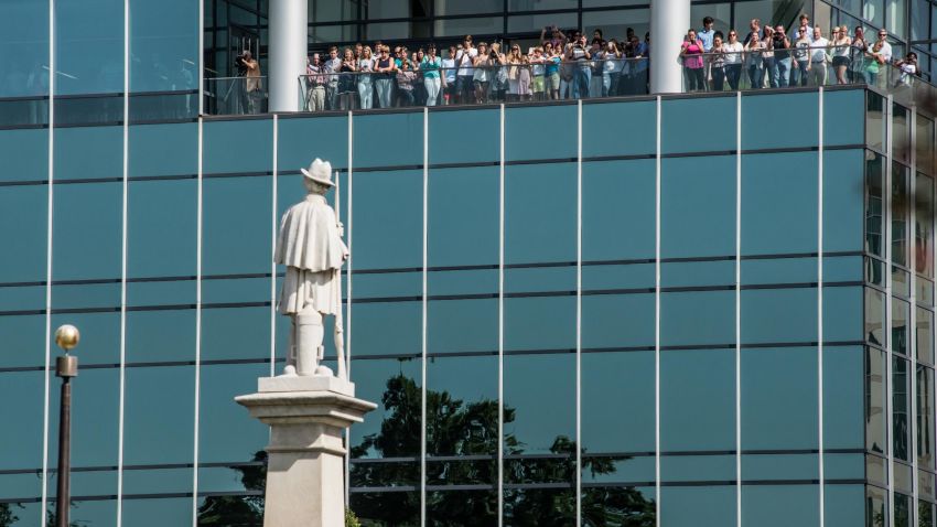 COLUMBIA, SC - JULY 10:  People watch from an office building as state law enforcement removes the Confederate battle flag from the South Carolina state house grounds July 10, 2015 in Columbia, SC. Yesterday, Governor Nikki Haley signed a bill ordering the removal of the flag from the capitol after the June murders at Emanuel AME Church in Charleston, South Carolina. (Photo by Sean Rayford/Getty Images)