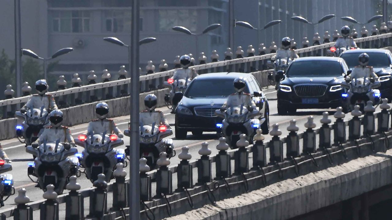 The car believed to be carrying North Korean leader Kim Jong Un is escorted by motorcycles in Beijing on Tuesday.