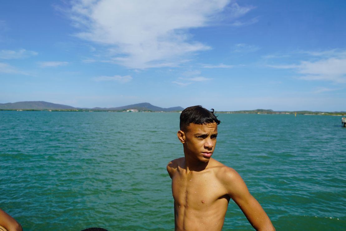 A Cuban boy swims in June 2018 in the sparkling blue waters of Guantanamo Bay from the town of Caimanera, Cuba. Residents of the town say the base bans their access to some of the area's best beaches and most pristine natural environments.