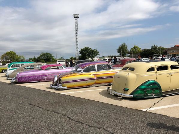 A gold-colored 1954 Chevrolet 210, christened "Sphinx," squats either side of "Eltesoro," a creamy green 1936 Dodge sedan, and "La Vida Rosa," a bright pink 1954 Mercury Monterey. 