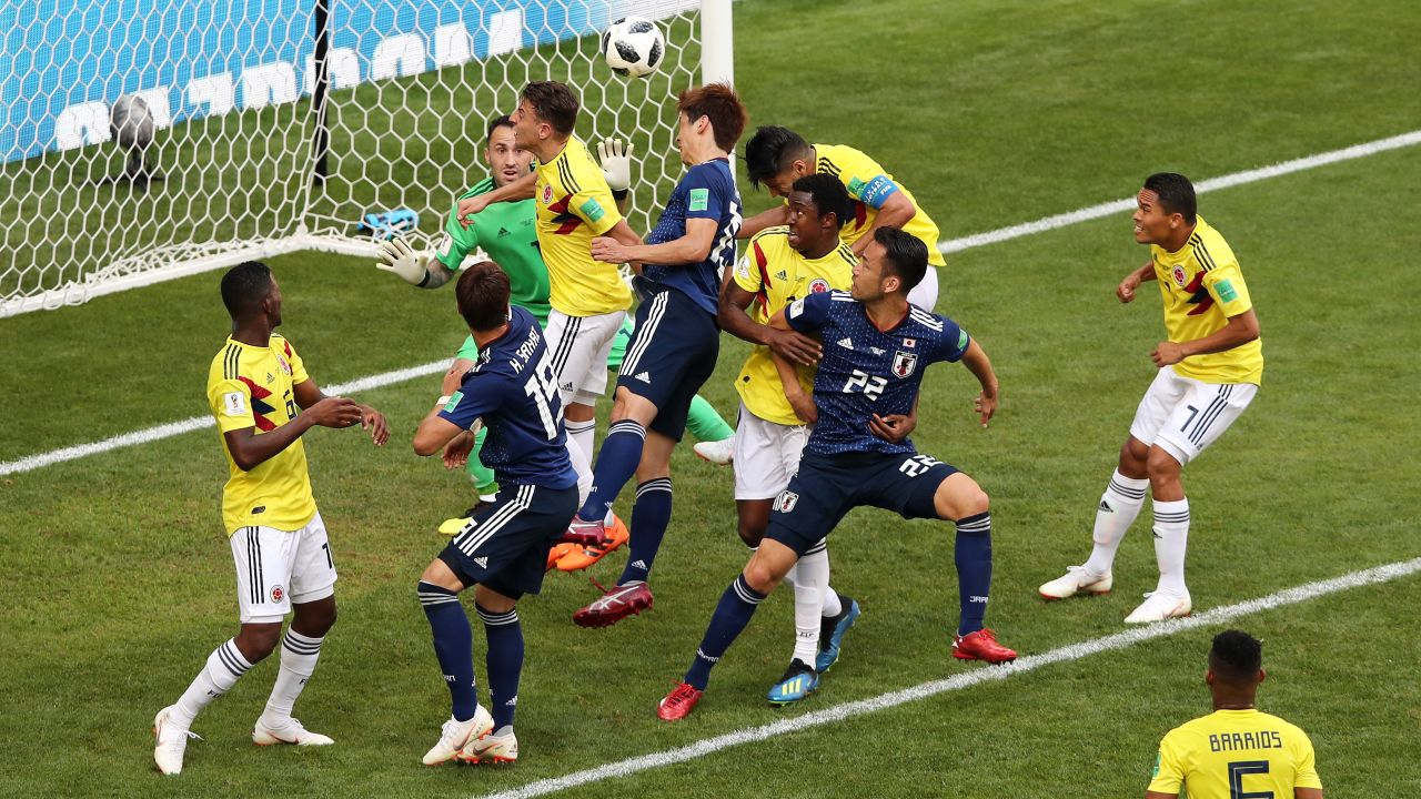 Yuya Osako of Japan heads the ball past David Ospina of Colombia.