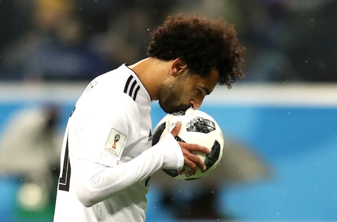 Mohamed Salah of Egypt kisses the ball before scoring from the penalty spot during the 2018 FIFA World Cup.