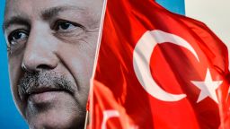 Turkish flags flutter nest to a huge portrait of Turkey's President and leader of the Justice and Development Party (AKP) Recep Tayyip Erdogan as he gives a speech during an AKP pre-election rally in Yenikapi Square in Istanbul on June 17, 2018. - With a week to go to crucial Turkish elections, the leader of the AKP  and his main rival of the secular Republican People's Party (CHP) are trading blows in an unexpectedly bruising fight to win control of the country. (Photo by Aris MESSINIS / AFP)        (Photo credit should read ARIS MESSINIS/AFP/Getty Images)