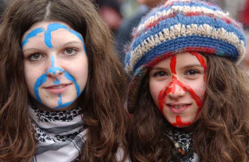 Two young protesters with their faces painted with a peace symbol for a 2004 demonstration in Rome.