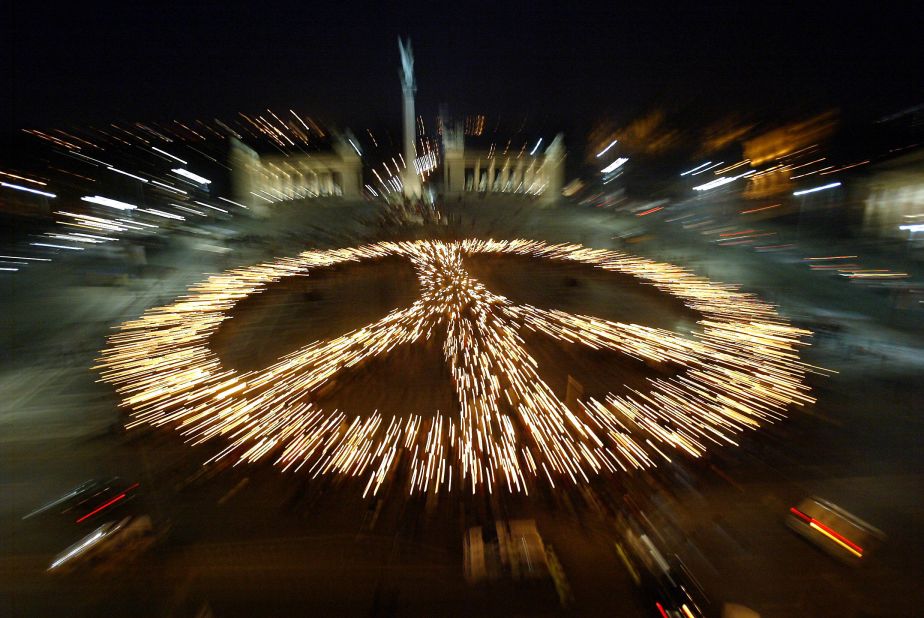 More than 4,000 activists with torches form a peace symbol on  Heroes' Square in central Budapest during a rally to demand the end of the US occupation of Iraq in 2006.