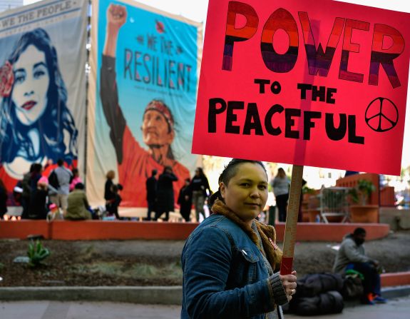 A participant holds signs as they march during the Women's March in Los Angeles in 2017.