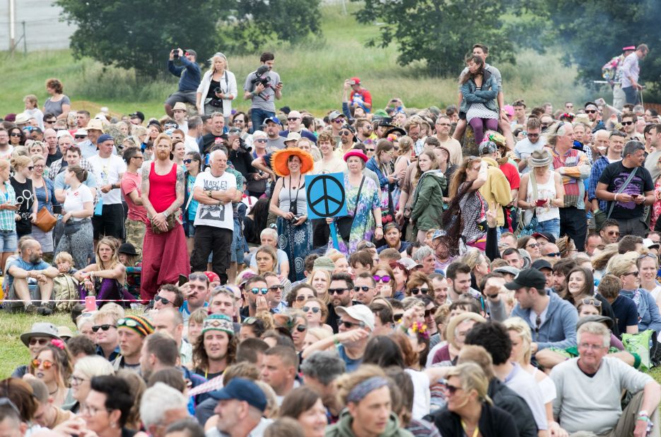 People gather to make a giant human peace sign at the 2017 Glastonbury Festival.