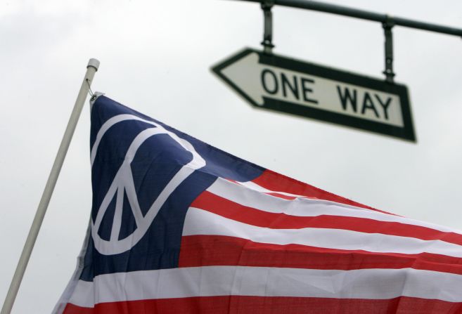 An US flag with the peace symbol instead of the stars representing the 50 states is held during a protest against the war in Iraq in January 2007 in Los Angeles.  