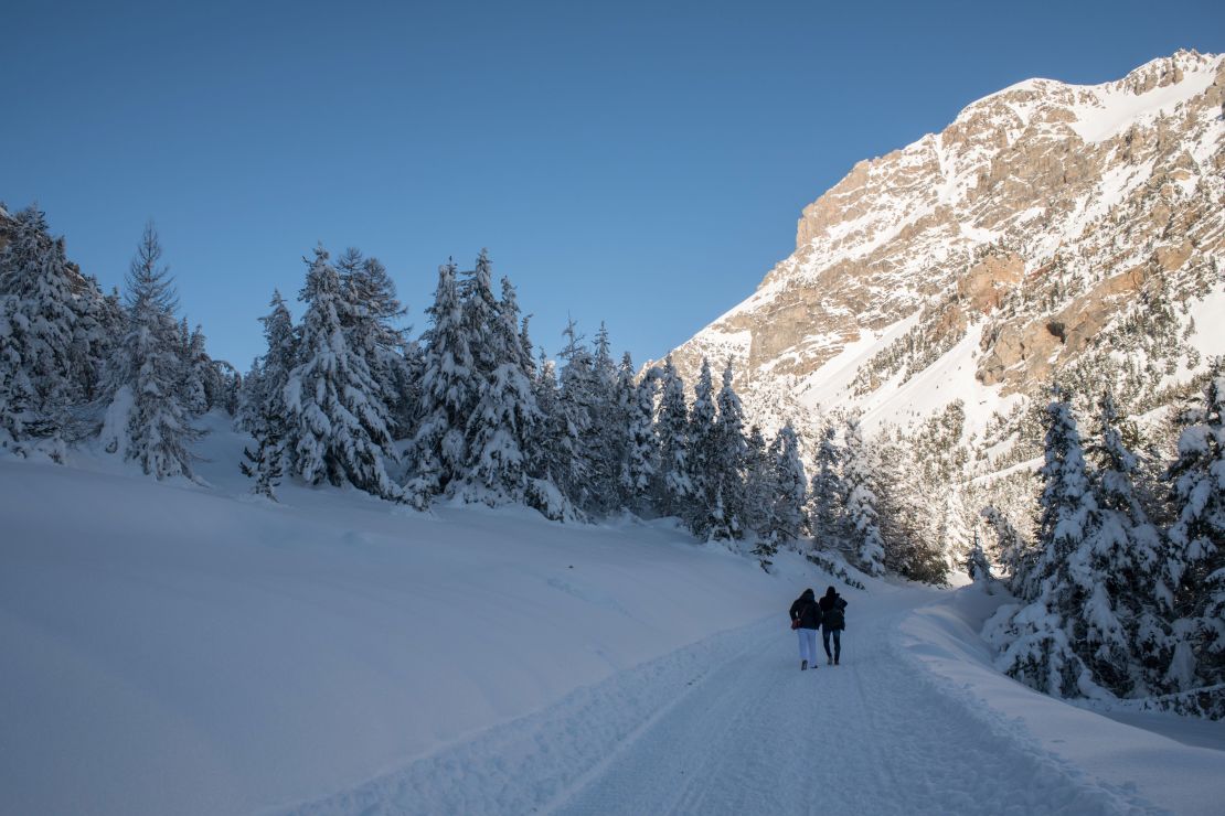 Migrants from Ivory Coast walk in the snow on their way to a snow-covered pass near Bardonecchia in January 2018.