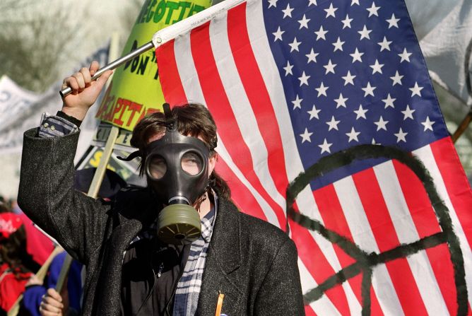 A demonstrator waves a flag marked with the peace symbol during an anti-Gulf War rally at the US Capitol in Washington in 1991.