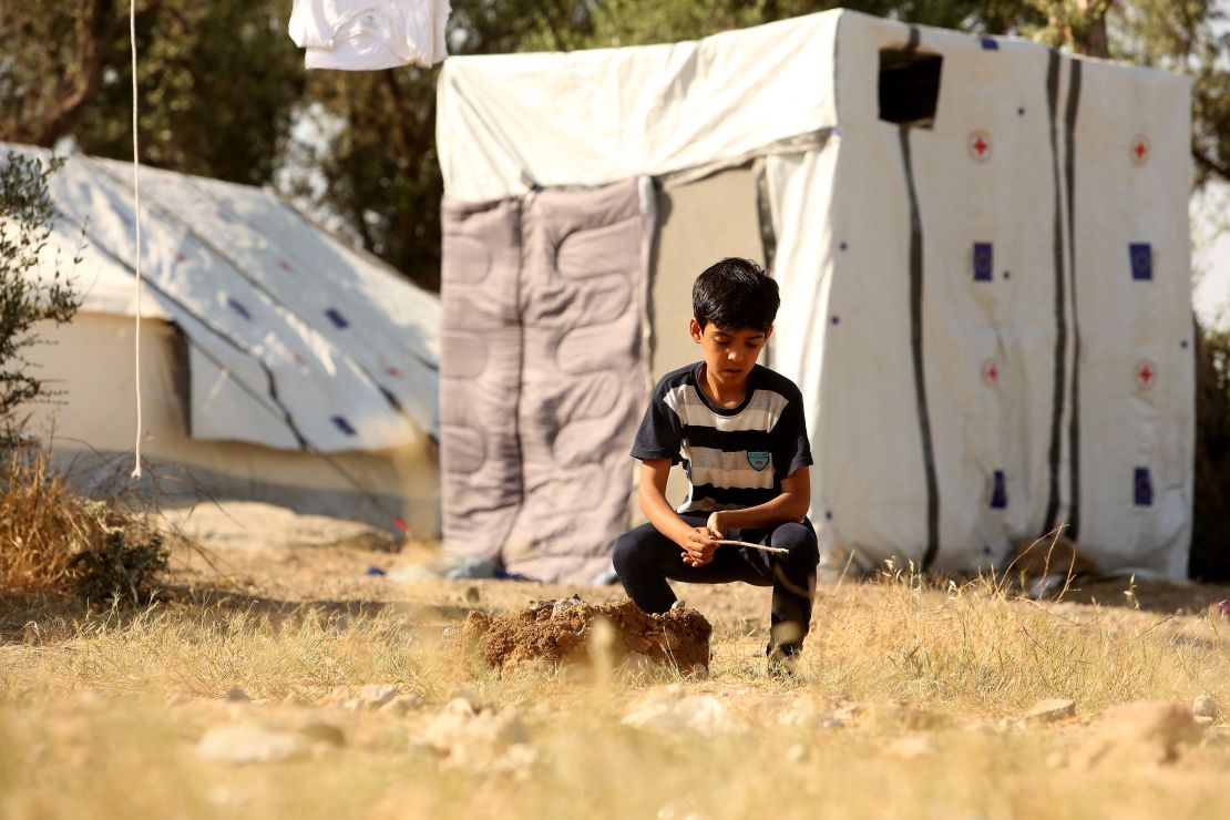 A refugee child plays alone at the Moria refugee camp on May 20, 2018, in Mytilene, Greece.  