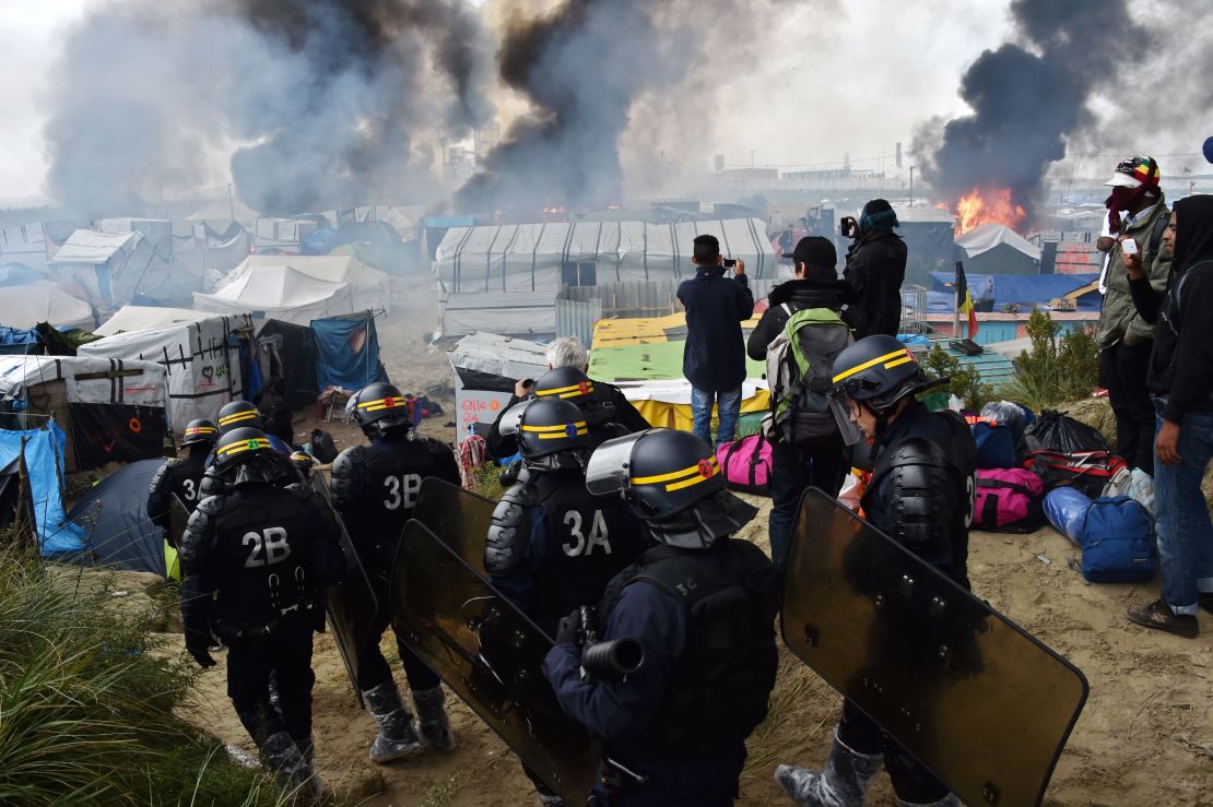 French anti-riot police officers arrive in October 2016 to clear the Calais "Jungle". 