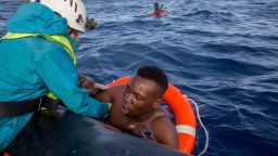 A member of German NGO Sea-Watch (L) helps a migrant to board a boat after he was recovered in the Mediterranean Sea on November 6, 2017.
During a shipwreck, five people died, including a newborn child. According to the German NGO Sea-Watch, which has saved 58 migrants, the violent behavior of the Libyan coast guard caused the death of five persons.

 / AFP PHOTO / Alessio Paduano        (Photo credit should read ALESSIO PADUANO/AFP/Getty Images)