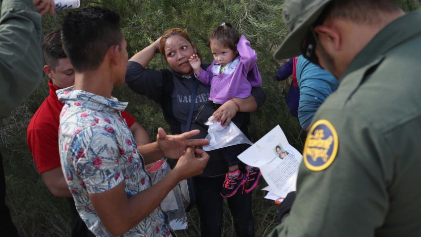 MCALLEN, TX - JUNE 12:  U.S. Border Patrol agents ask a group of Central American asylum seekers to remove hair bands and weddding rings before taking them into custody on June 12, 2018 near McAllen, Texas. The immigrant families were then sent to a U.S. Customs and Border Protection (CBP) processing center for possible separation. U.S. border authorities are executing the Trump administration's "zero tolerance" policy towards undocumented immigrants. U.S. Attorney General Jeff Sessions also said that domestic and gang violence in immigrants' country of origin would no longer qualify them for political asylum status.  (Photo by John Moore/Getty Images)