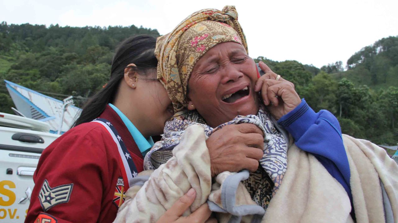 A woman cries as she finds out her family are listed as missing, at the Lake Toba ferry port in the province of North Sumatra on June 19, 2018, after a boat capsized the day before.