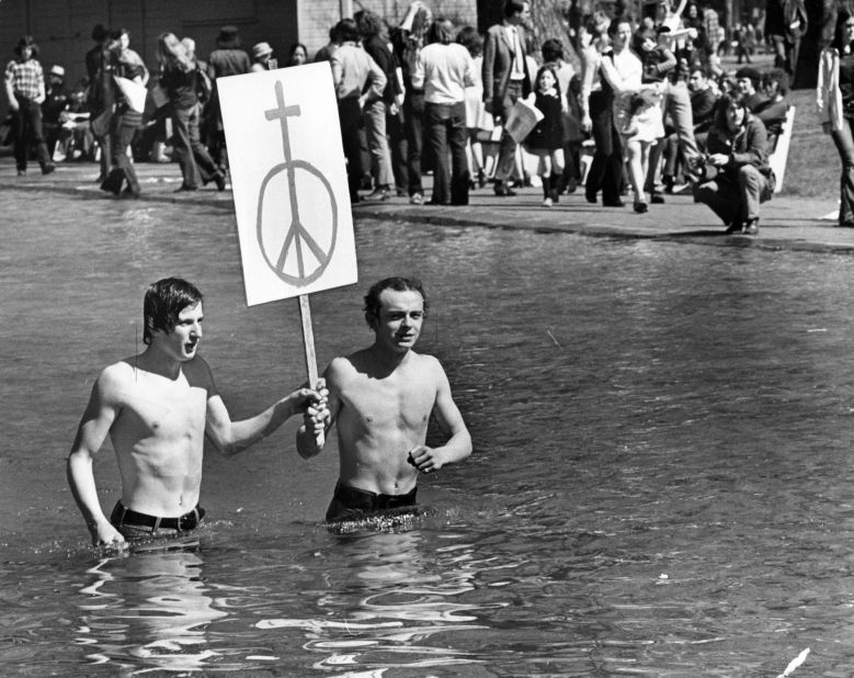 Demonstrators from South Boston High School carry a sign with the symbol of a cross on top of a peace sign during a rally to peacefully protest the Vietnam War in May 1971. 