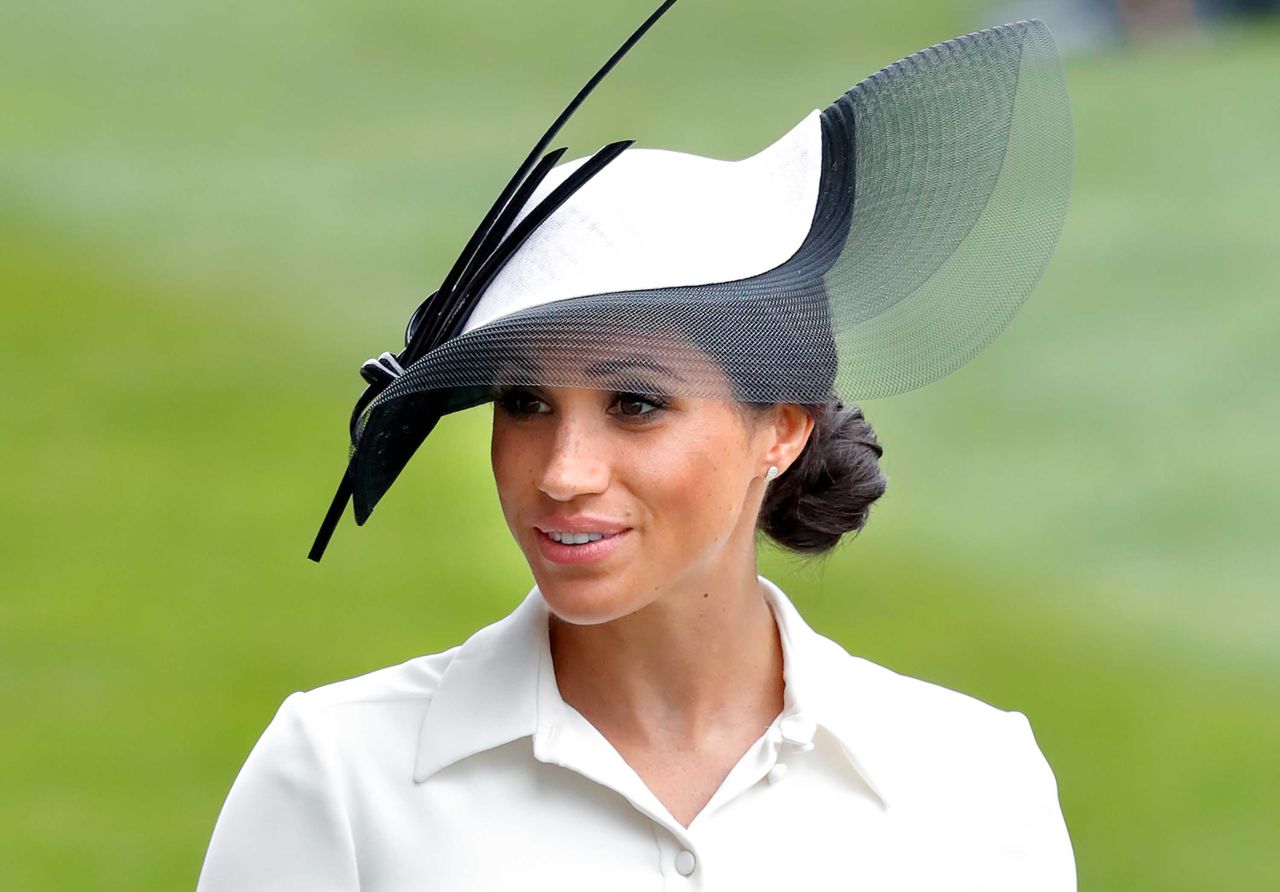 Meghan the Duchess of Sussex attends day one of Royal Ascot wearing a sculptural Philip Treacy hat and an elegant Givenchy dress.
