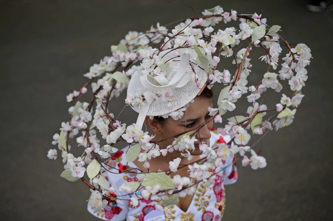 A women wears a delicate white floral design on day one of the races. 