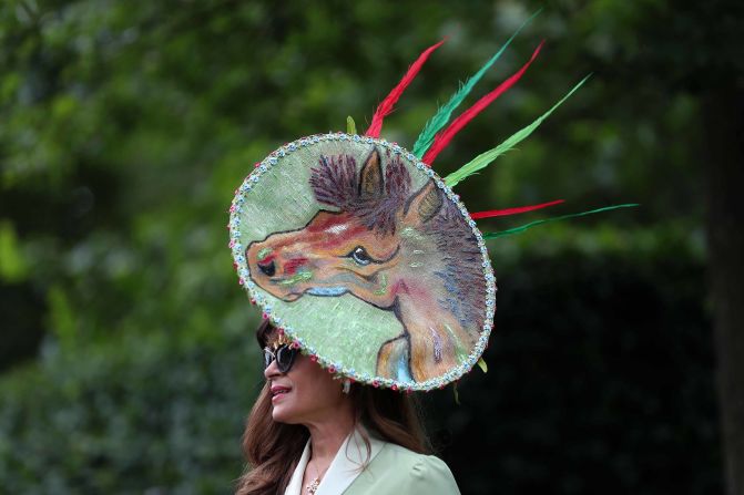 A racegoer poses for a photograph as she arrives on day one of the Royal Ascot horse racing meet.