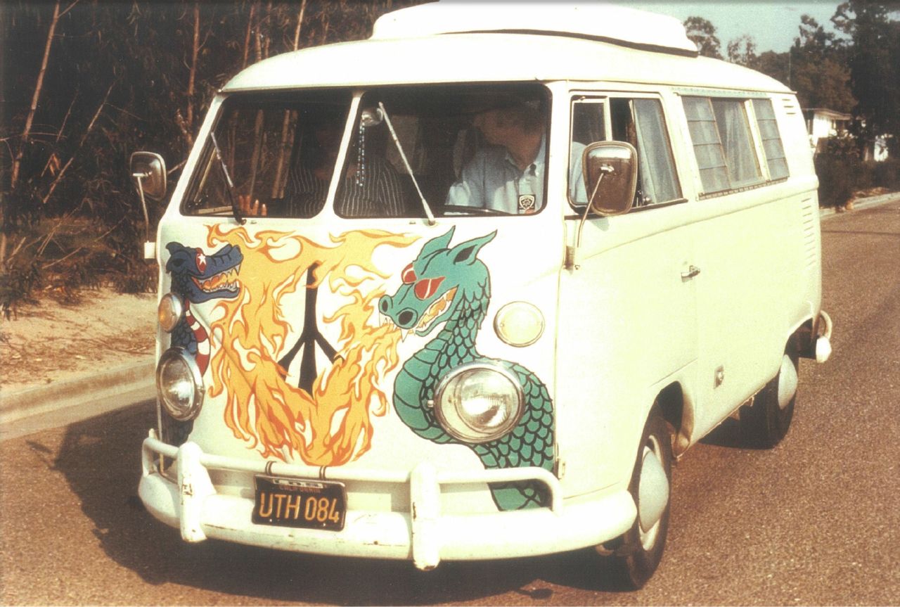 A VW bus with an elaborately painted peace symbol replacing the VW bug.