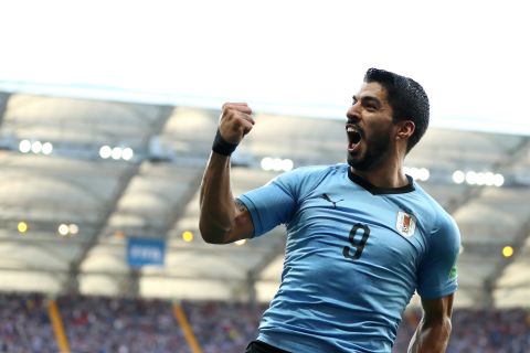 Uruguay's Luis Suarez celebrates after scoring against Saudi Arabia. It was the only goal of the match, and the final result meant Uruguay and Russia would both advance to the tournament's knockout stage.