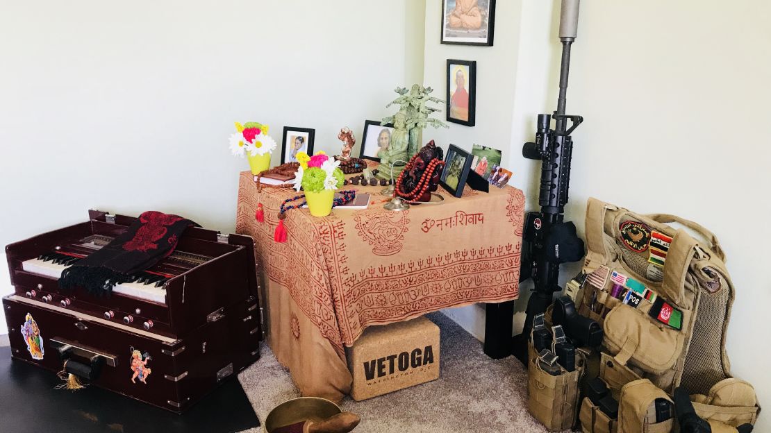 Justin Blazejewski sets his rifle and body armor next to his shrine as a way to embrace his past.  