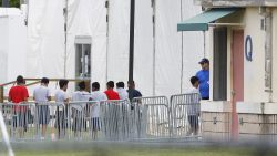 Immigrant children walk in a line outside the Homestead Temporary Shelter for Unaccompanied Children, a former Job Corps site that now houses them, on Wednesday, June 20, 2018, in Homestead, Fla. (AP Photo/Brynn Anderson)