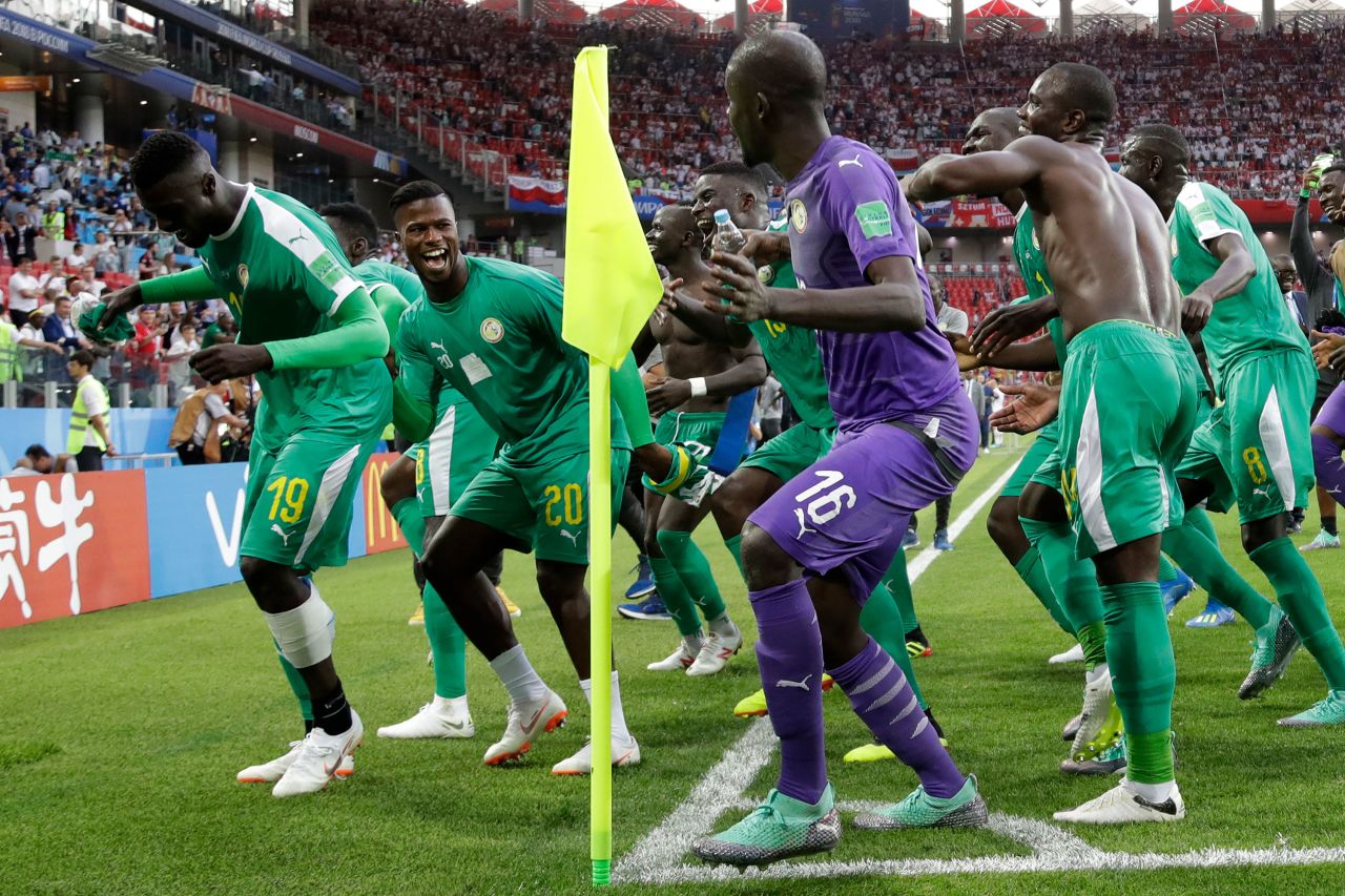 Members of the Senegal team celebrate after defeating Poland 2-1 in their match on June 19.