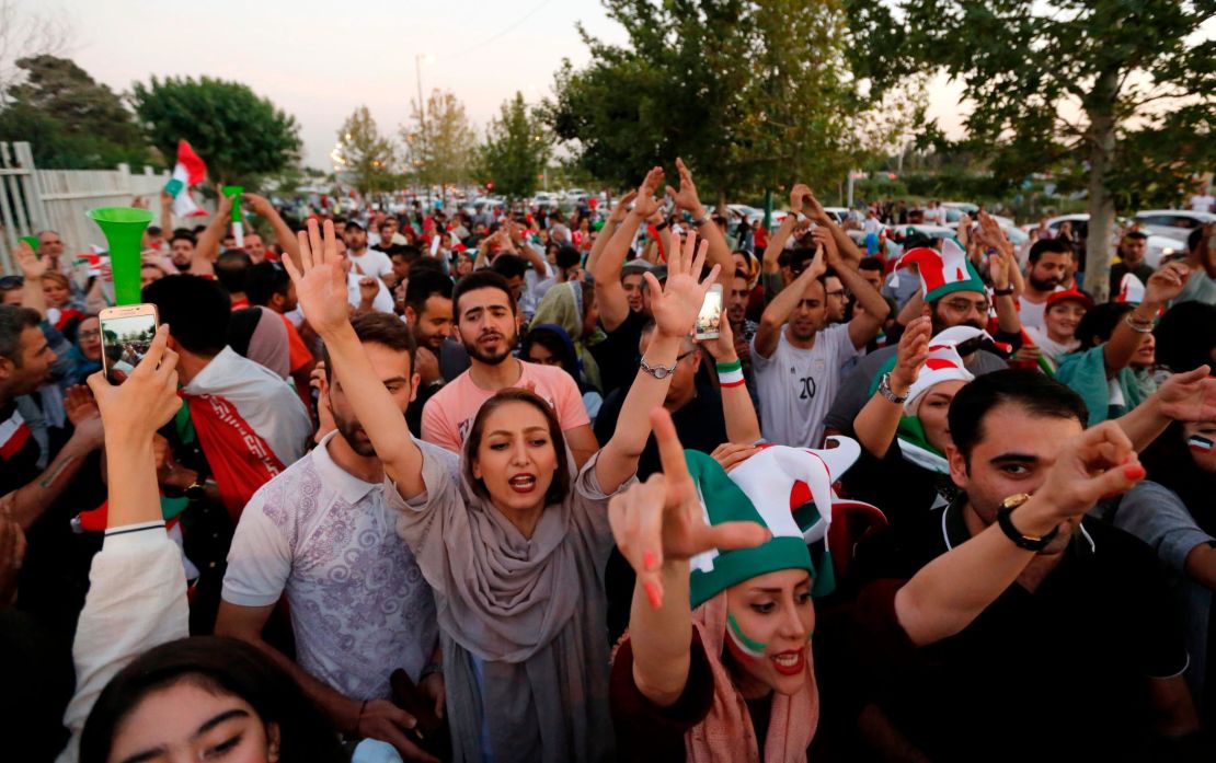 Iranian football supporters arrive at the Azadi Stadium to watch the match against Spain on a big screen.