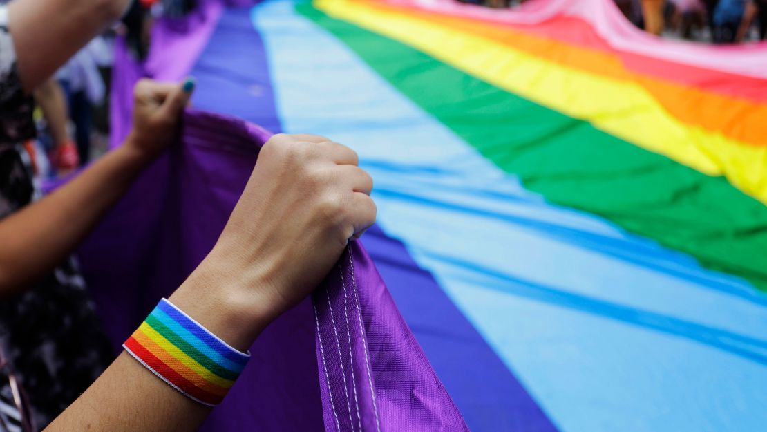 Revelers at a Pride parade hold up a giant rainbow flag in Sao Paulo, Brazil, on June 3, 2018. 