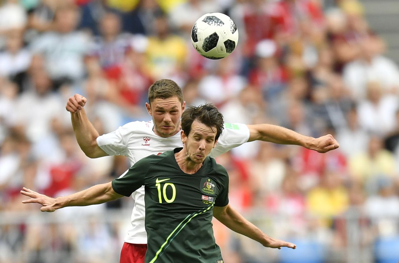 Australia's Robbie Kruse, foreground, and Denmark's Henrik Dalsgaard go for a header during the teams' 1-1 draw on June 21.