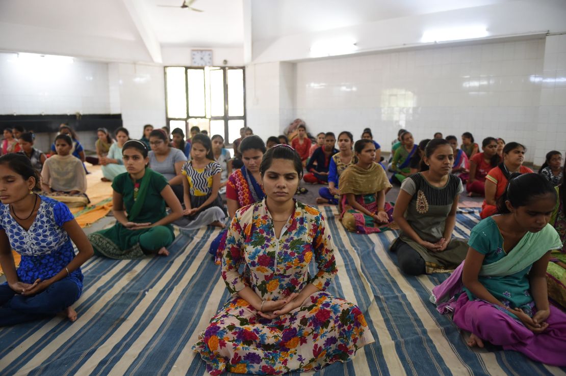Indian visually impaired and partially visually impaired girls participate in a yoga class at Andh Kanya Prakash Gruh in Ahmedabad on June 20, 2018, on the eve of International Yoga Day.