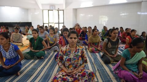 Indian visually impaired and partially visually impaired girls participate in a yoga class at Andh Kanya Prakash Gruh in Ahmedabad on June 20, 2018, on the eve of International Yoga Day.