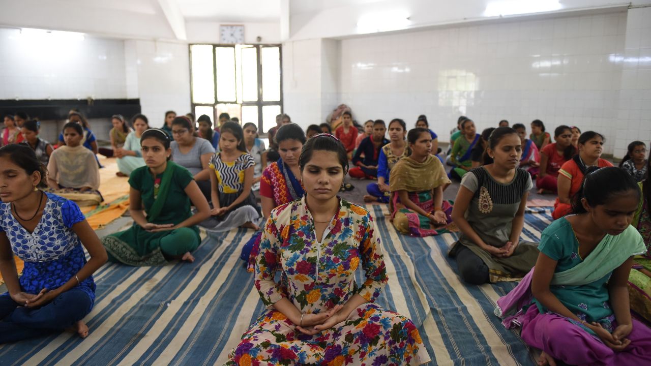 Indian visually impaired and partially visually impaired girls participate in a yoga class at Andh Kanya Prakash Gruh in Ahmedabad on June 20, 2018, on the eve of International Yoga Day.