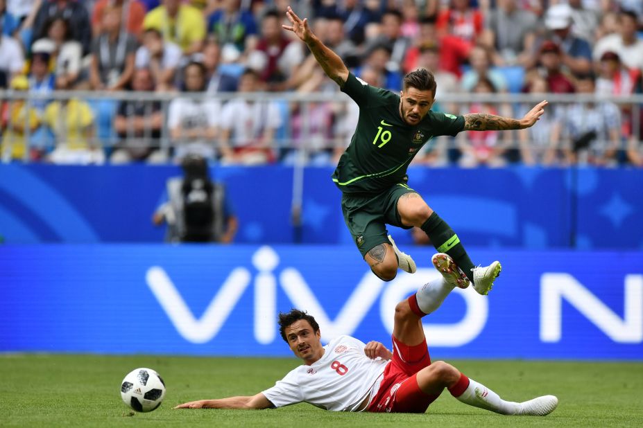 Australia's Joshua Risdon jumps over Thomas Delaney.