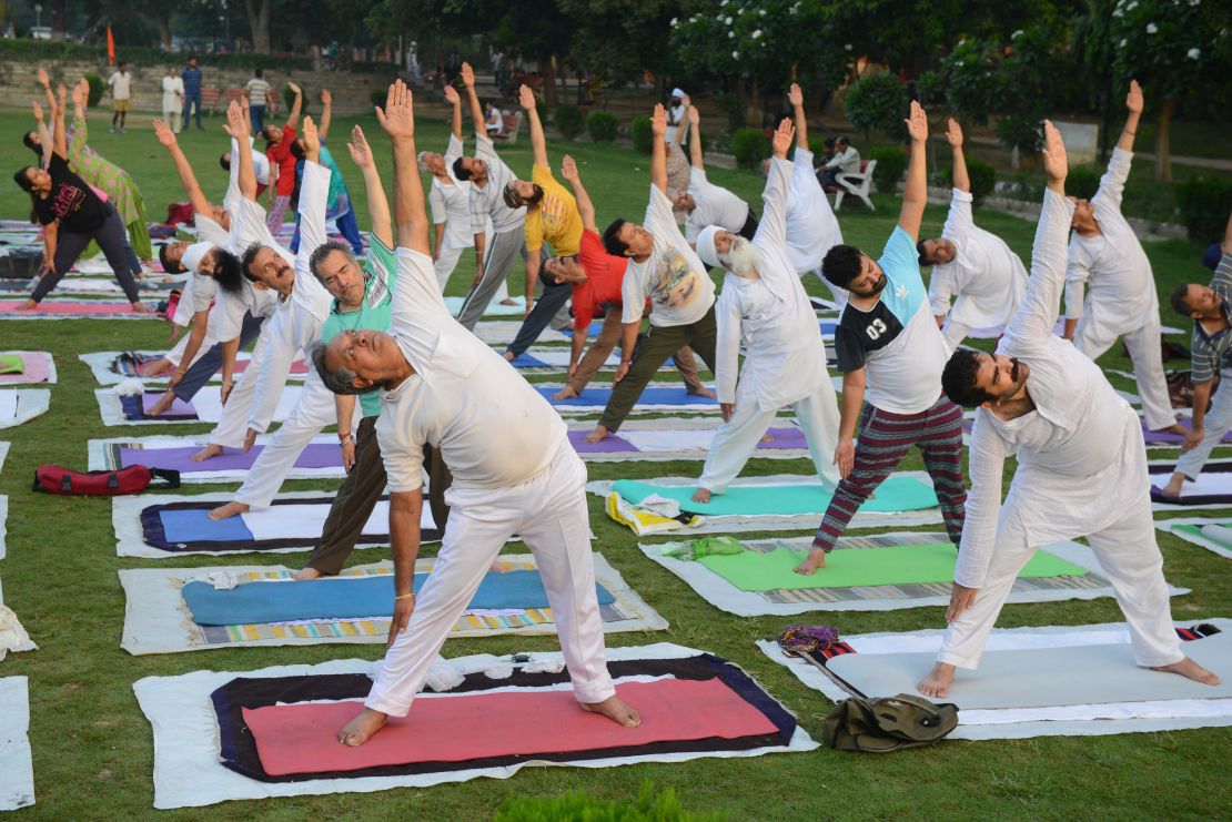 Indian yoga practitioners take part in a yoga session ahead of International Yoga Day at a park in Amritsar on June 20, 2018.