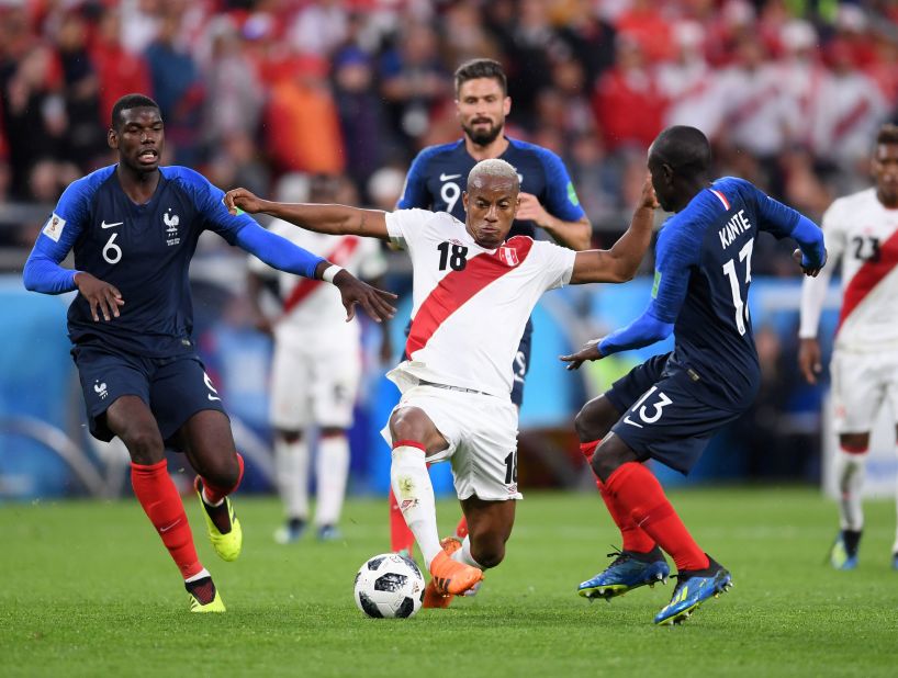 Peru's Andre Carrillo is challenged by French players Paul Pogba, left, and N'Golo Kante.