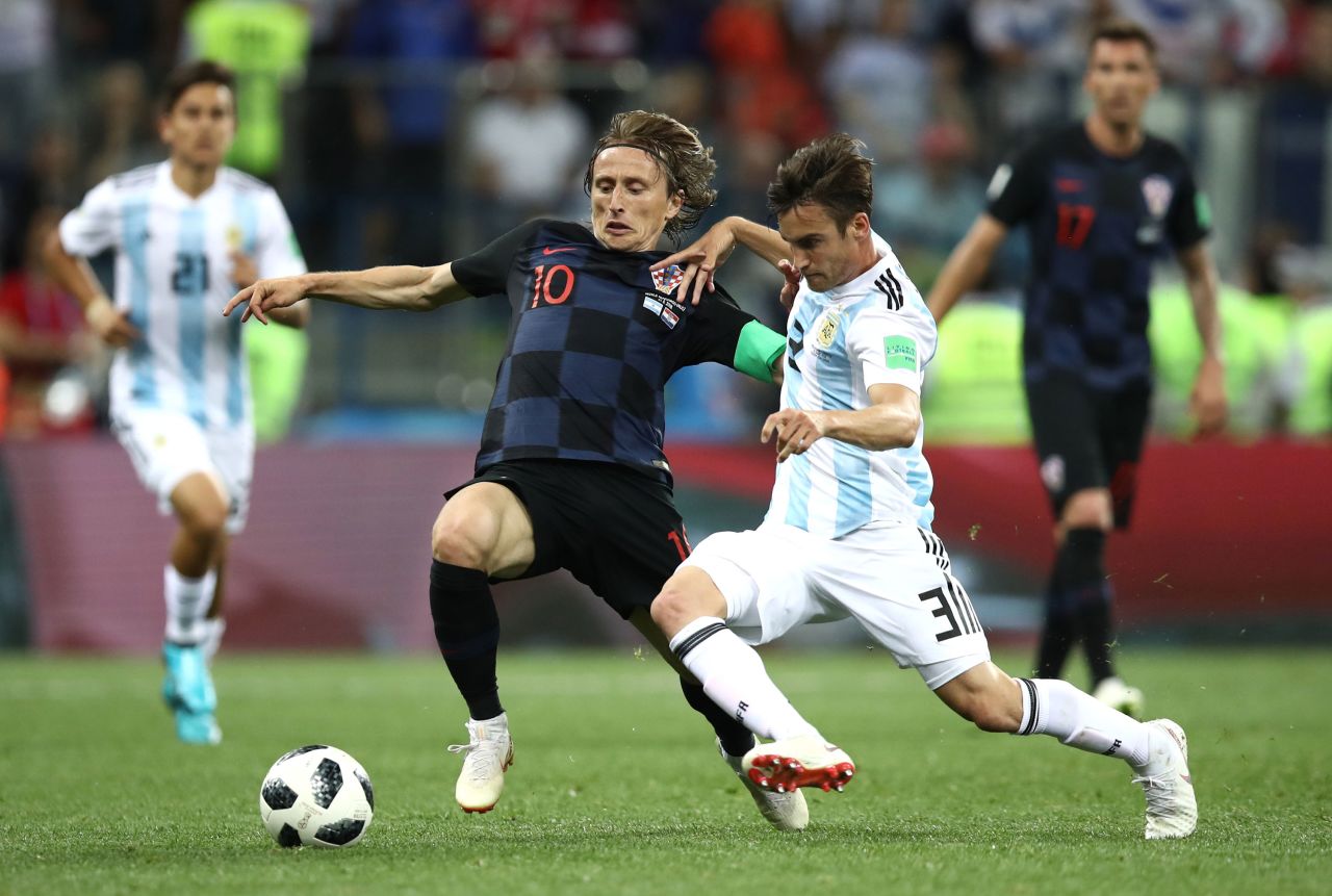 Croatia's Luka Modric is tackled by Argentina's Nicolas Tagliafico.