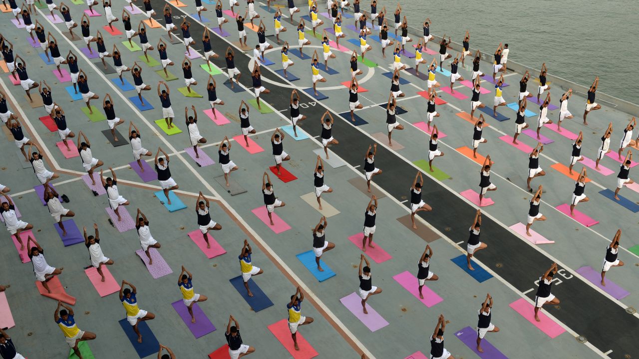 Members of the Indian Armed Forces do yoga on the INS Viraat, an aircraft carrier anchored in Mumbai, India, on Thursday, June 21. June 21 was International Yoga Day.