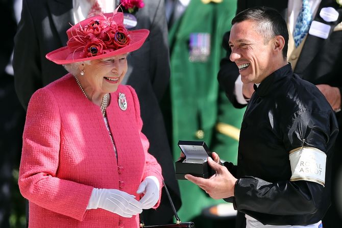 The Queen presented the silverware to the colorful Dettori as well as winning trainer John Gosden.