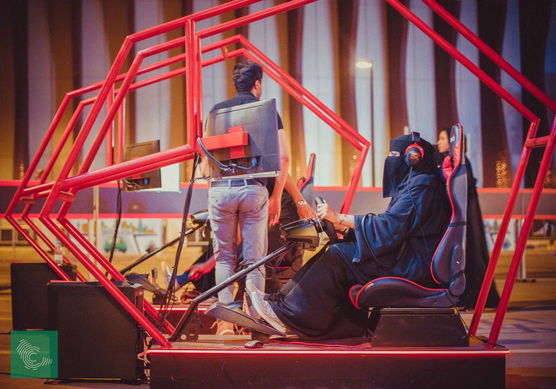 A woman tries a driving simulator at a government-organized road safety event at Riyadh Park Mall in the Saudi capital on Thursday.