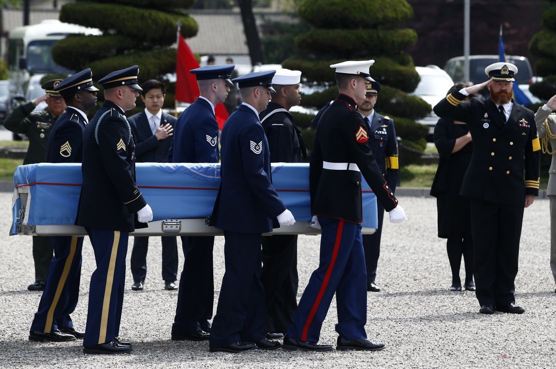 United Nations Command honor guards carry a casket containing the remains of a UNC soldier killed inside North Korea during the 1950-53 Korean War, during a joint repatriation ceremony at Knight Field at Yongsan garrison in Seoul on April 28, 2016. 