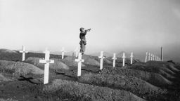 On December 13, 1950 during memorial services at the First Marine cemetery in Hungnam, Korea, Corporal Charles Price sounds "Taps" over the graves of fallen U.S. Marines following the division's heroic break-out from Chosin Reservoir. (Photo by © CORBIS/Corbis via Getty Images)